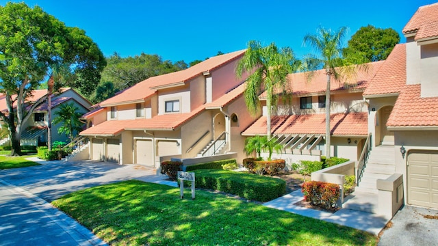 mediterranean / spanish-style house with a garage