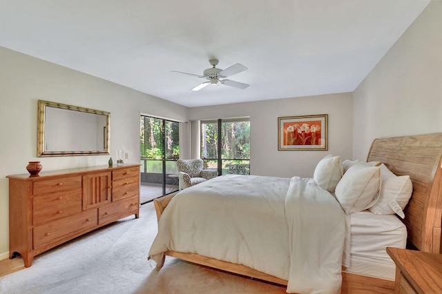 bedroom with ceiling fan, light carpet, and access to outside