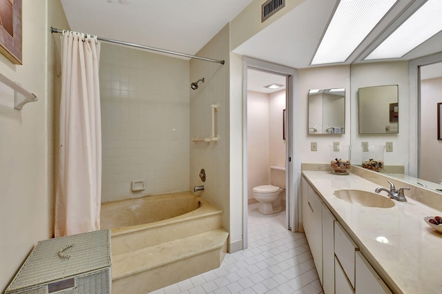 full bathroom featuring tile patterned floors, vanity, shower / bath combo, and toilet