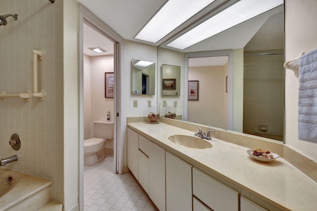 full bathroom with tile patterned flooring, vanity, toilet, and tiled shower / bath combo