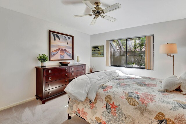 bedroom featuring ceiling fan and light carpet