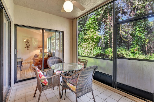 sunroom / solarium featuring ceiling fan