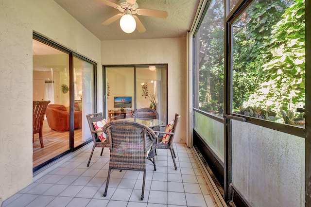 sunroom / solarium with plenty of natural light and ceiling fan