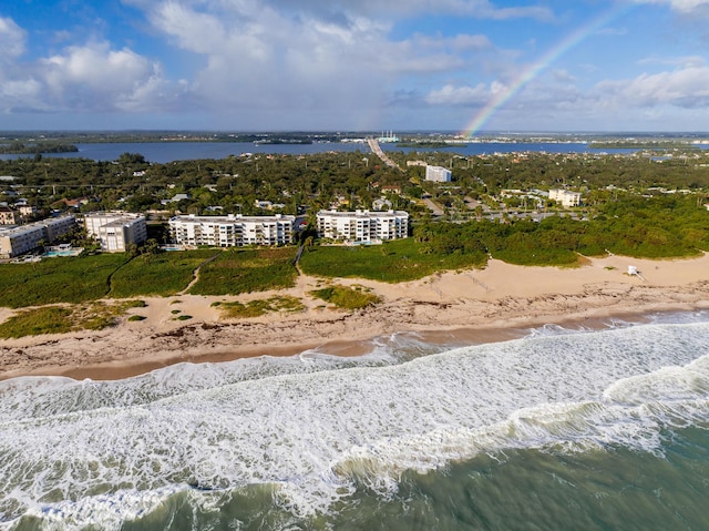 aerial view with a water view and a beach view