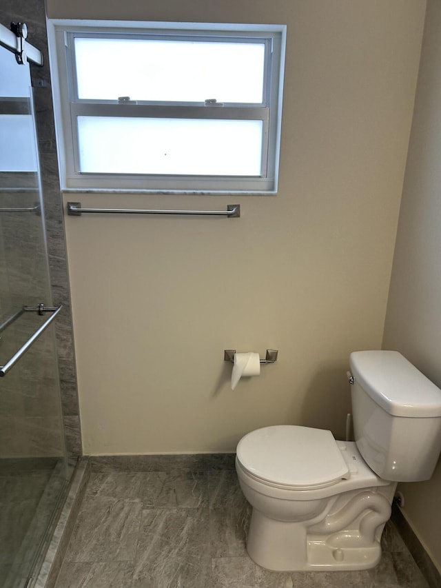 bathroom with toilet and a wealth of natural light