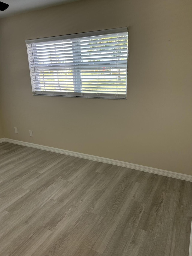 spare room with hardwood / wood-style floors