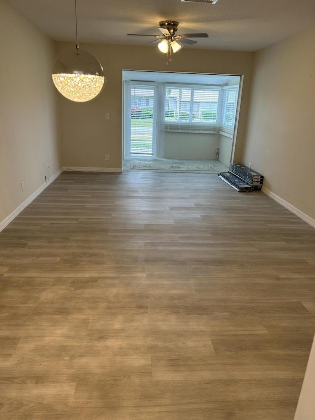 spare room with ceiling fan and wood-type flooring