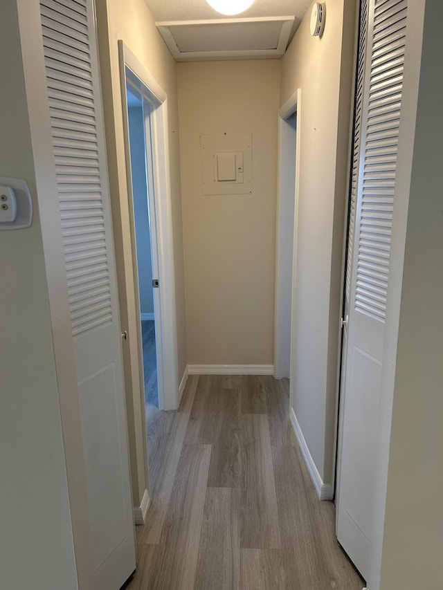 corridor with light wood-type flooring