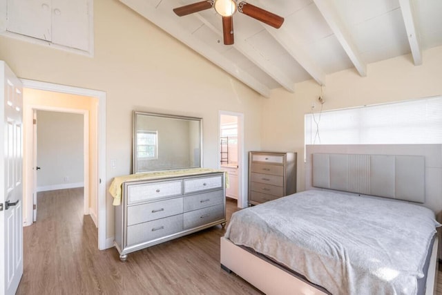 bedroom featuring ceiling fan, beam ceiling, high vaulted ceiling, hardwood / wood-style floors, and connected bathroom