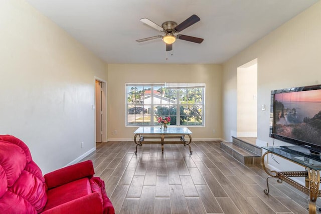 living area with hardwood / wood-style floors and ceiling fan