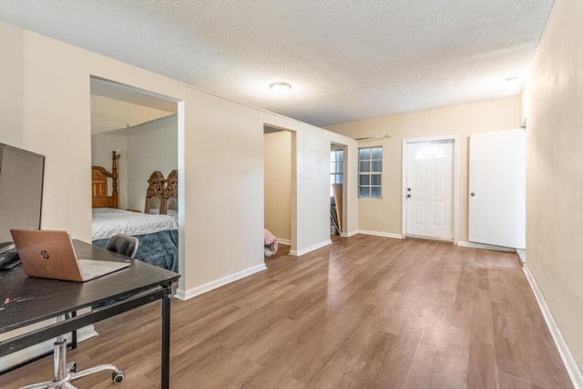 entrance foyer with light wood-type flooring and a textured ceiling