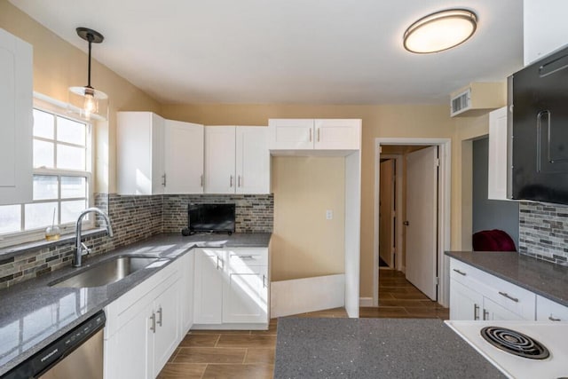 kitchen with tasteful backsplash, sink, pendant lighting, dishwasher, and white cabinetry