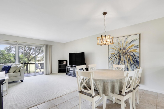 dining room featuring a notable chandelier and light tile patterned flooring