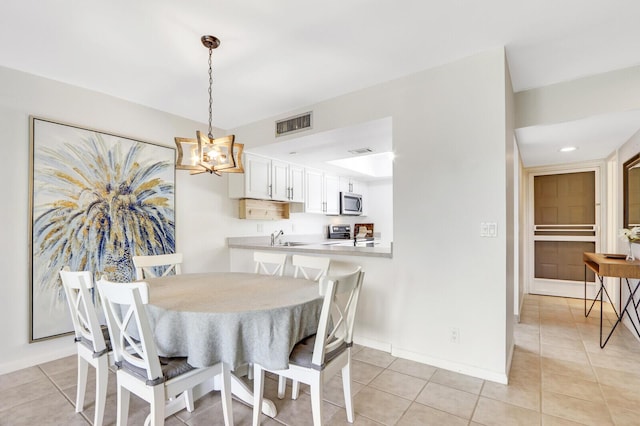 dining room with light tile patterned floors and sink