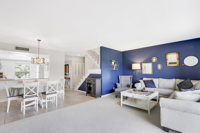 living room featuring a notable chandelier and light tile patterned floors