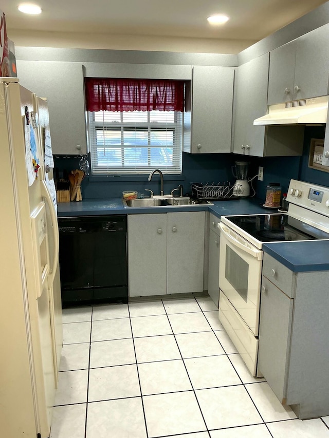 kitchen with gray cabinetry, light tile patterned flooring, white appliances, and sink