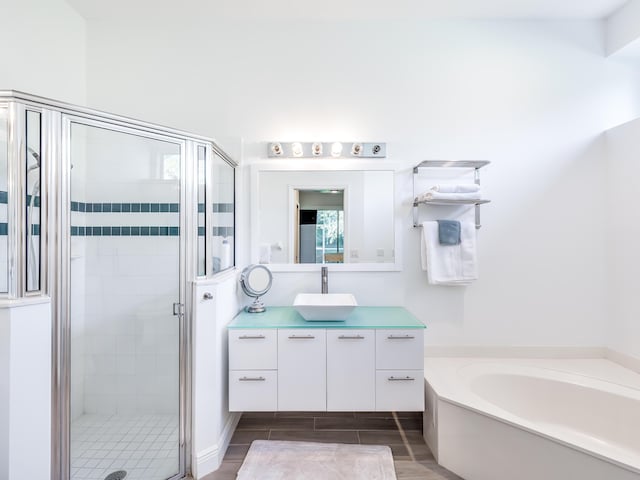 bathroom with separate shower and tub, vanity, and hardwood / wood-style flooring