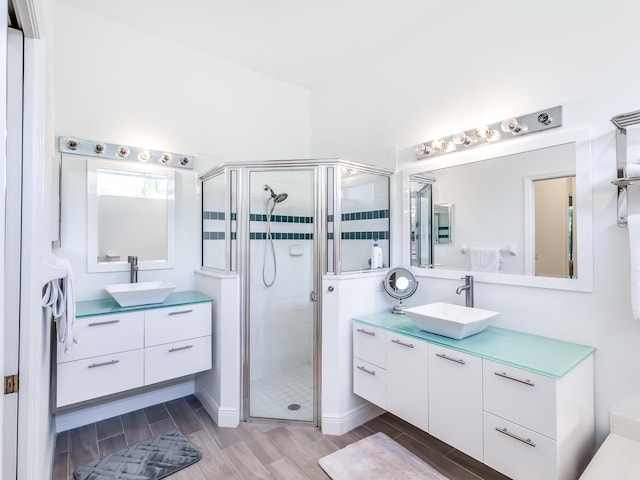 bathroom with vanity, hardwood / wood-style flooring, and walk in shower