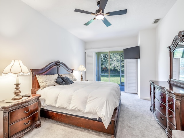 carpeted bedroom featuring ceiling fan, access to exterior, and multiple windows