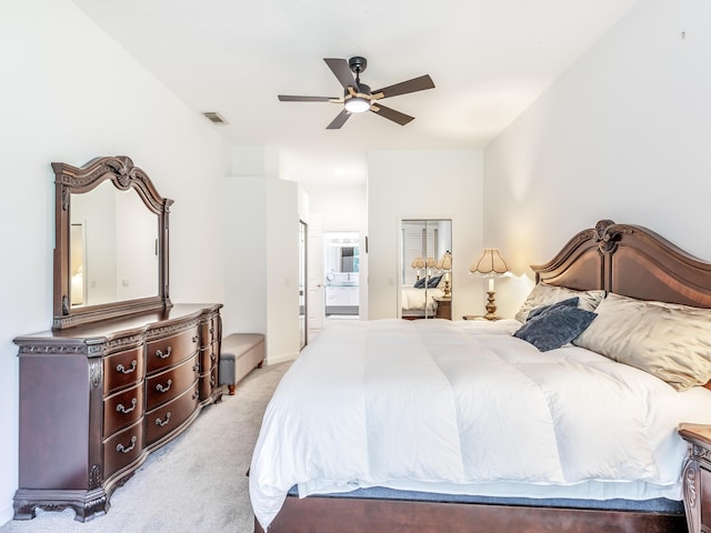 bedroom featuring connected bathroom, ceiling fan, and light carpet