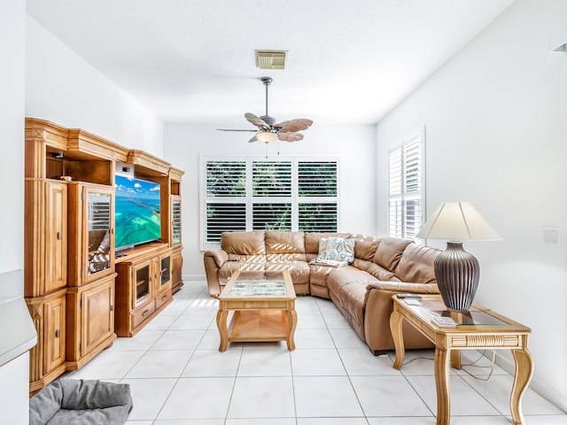 tiled living room featuring ceiling fan