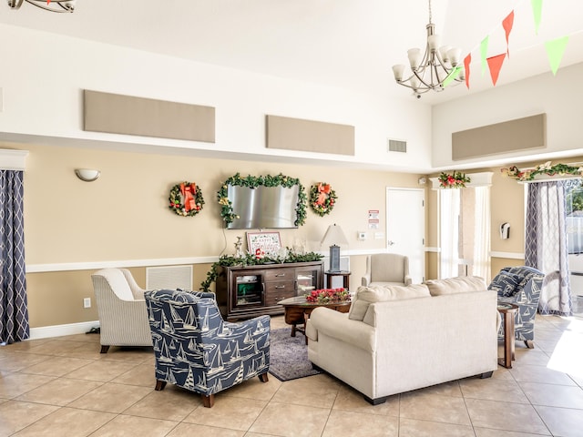 living room featuring a notable chandelier and light tile patterned floors