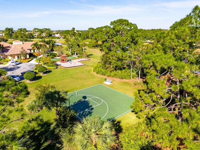 view of sport court featuring a yard