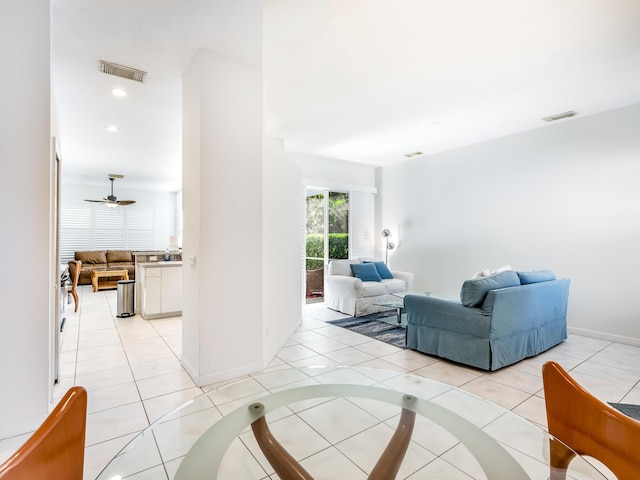 tiled living room with ceiling fan