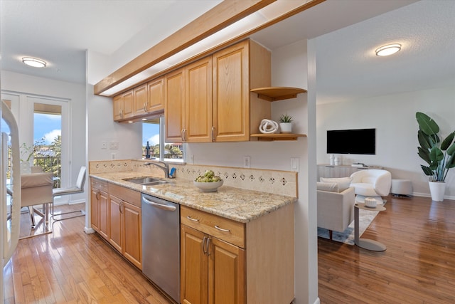 kitchen with a wealth of natural light, dishwasher, light hardwood / wood-style floors, and sink