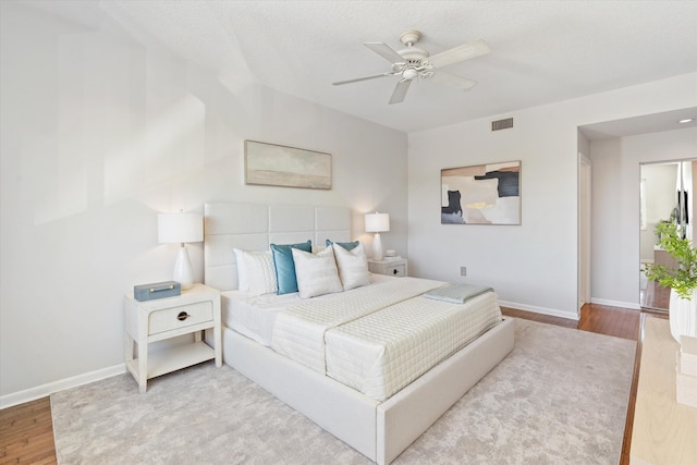 bedroom featuring ceiling fan and light hardwood / wood-style flooring