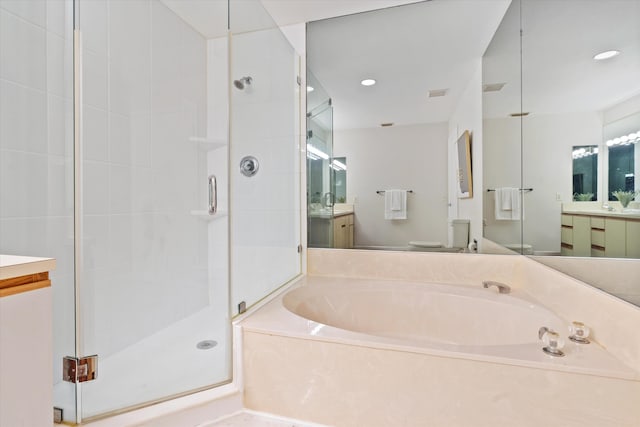 full bathroom featuring shower with separate bathtub, vanity, and toilet