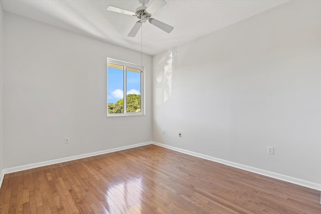 unfurnished room featuring ceiling fan, hardwood / wood-style floors, and a textured ceiling