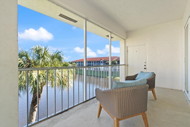 sunroom / solarium with a water view