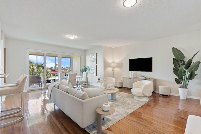 living room featuring a textured ceiling and hardwood / wood-style flooring