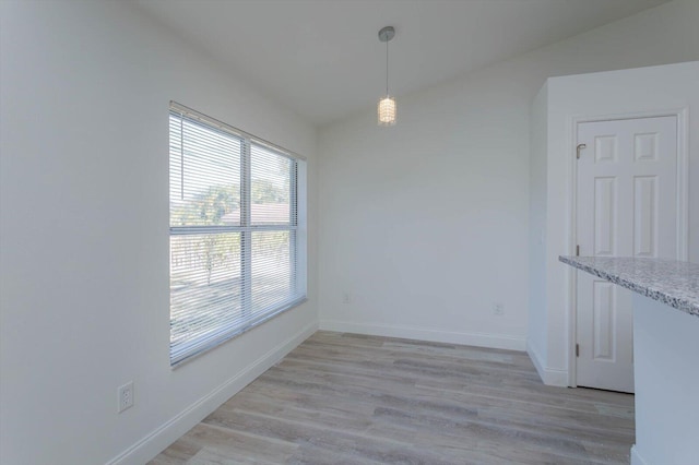 unfurnished dining area with light wood-type flooring