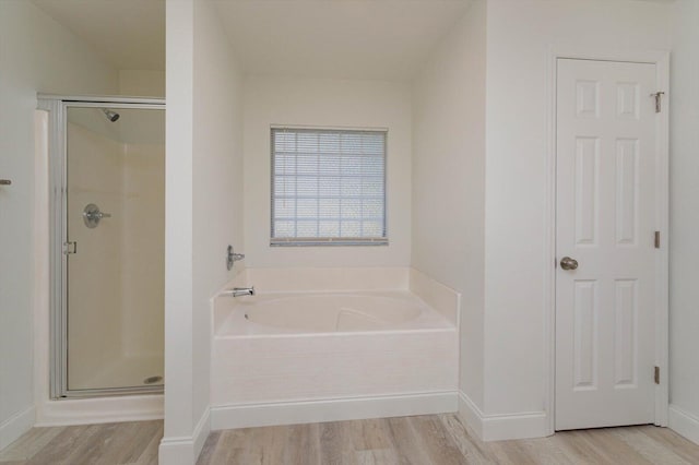 bathroom with plus walk in shower and hardwood / wood-style flooring