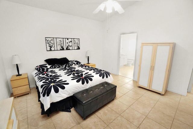 bedroom with light tile patterned floors, connected bathroom, a ceiling fan, and vaulted ceiling