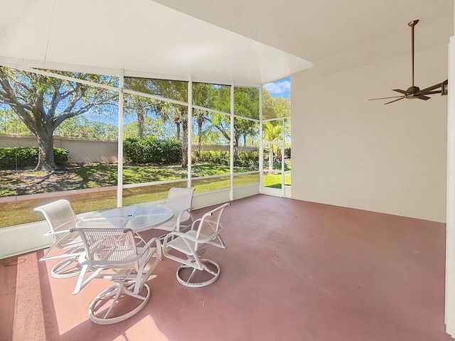 unfurnished sunroom featuring ceiling fan