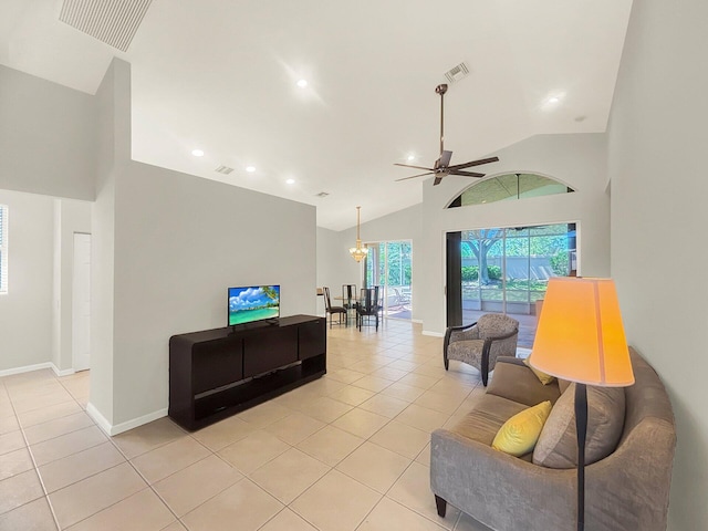 living room with light tile patterned floors, visible vents, baseboards, and high vaulted ceiling