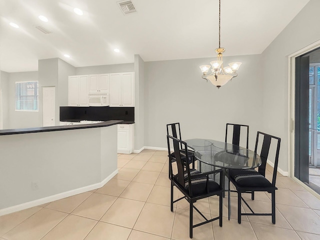 dining room with light tile patterned floors, baseboards, and visible vents