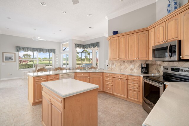 kitchen featuring kitchen peninsula, light brown cabinetry, ornamental molding, and appliances with stainless steel finishes