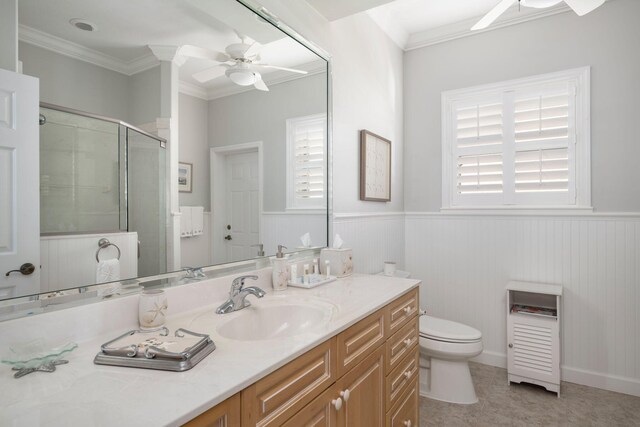 bathroom with vanity, ceiling fan, toilet, ornamental molding, and walk in shower