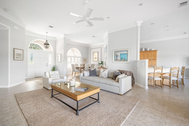 living room with light tile patterned floors, ceiling fan, and crown molding