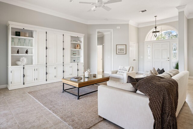 living room with ceiling fan, light tile patterned flooring, ornamental molding, and built in features