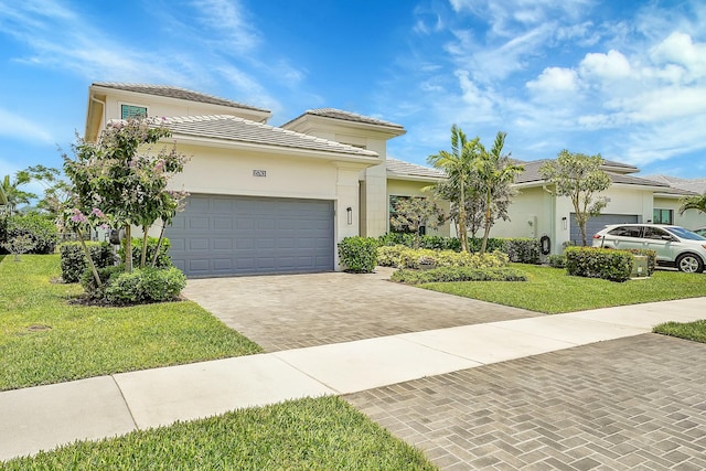 view of front of house with a garage and a front lawn