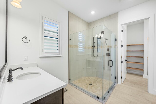 bathroom featuring vanity and an enclosed shower