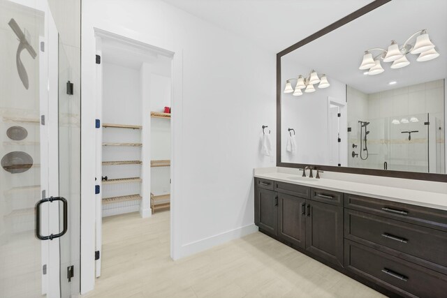 spacious closet featuring light hardwood / wood-style floors