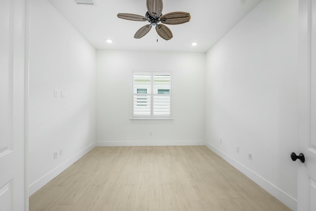 spare room with ceiling fan and light wood-type flooring