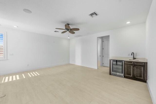 unfurnished room with ceiling fan and light hardwood / wood-style floors