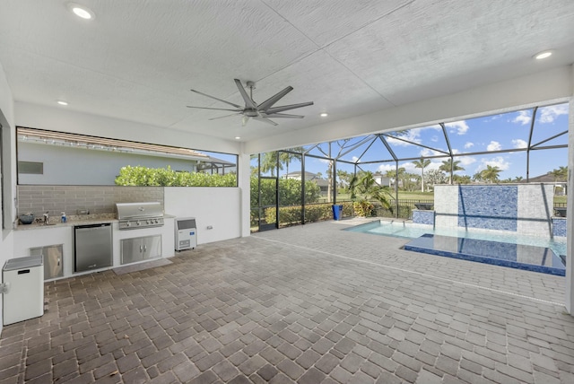 view of patio with ceiling fan, a grill, a lanai, and exterior kitchen